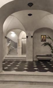 a building with a lobby with a staircase and a stair case at Pellicceria Guest House in Genova