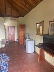 a living room with a white refrigerator and a tv at The Victory Villa in Parrot Hall