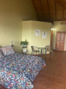 a bedroom with a bed and a table and chairs at The Victory Villa in Parrot Hall