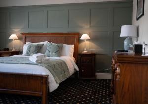 A bed or beds in a room at The Bear, Cowbridge