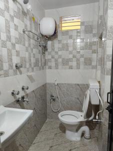 a bathroom with a toilet and a sink at Jagannatha Guest House in Puri