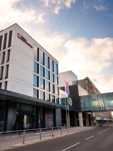 a building on the side of a street at Hilton Garden Inn Krakow Airport in Kraków