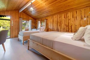 A bed or beds in a room at Etenna Beach Bungalows