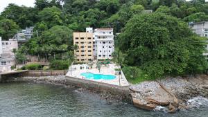 an aerial view of a swimming pool in the water at Ilha Porchat Hotel in São Vicente