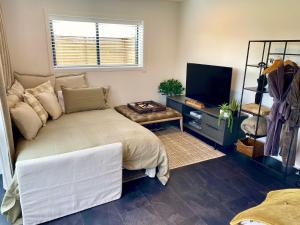 a bedroom with a large bed and a television at Matamata Country B&B in Matamata