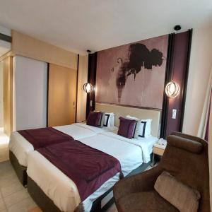 Tempat tidur dalam kamar di BEYZAA HOTEL AND SUITES