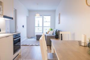 a kitchen and living room with a table and a couch at Snowflake Suites I in Rovaniemi