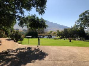 a park with a field of grass and trees at The Water Wheel in Vryheid