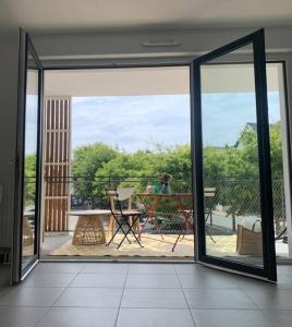 Habitación con puerta corredera de cristal y vistas a un patio. en Appartement neuf T2 en Saint-Pierre-Quiberon