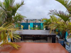 a large table on the roof of a house with palm trees at Jagannatha Guest House in Puri