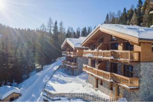 a ski lodge in the snow with snow covered trees at Turracher Zirbenlodges in Turracher Hohe