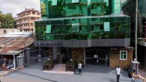 a group of people standing in front of a building at HADJENS HOTEL in Mwanza