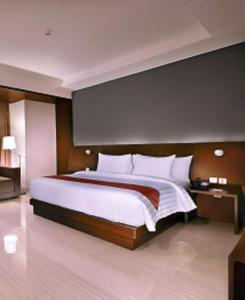 A bed or beds in a room at Aston Imperial Bekasi Hotel & Conference Center