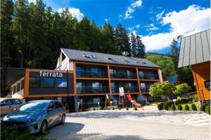 a building with a car parked in front of it at Chata pod Martinkami in Martin