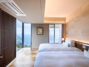 Tempat tidur dalam kamar di Atami Sekaie