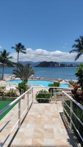 a walkway leading to the beach with a view of the water at Ilha Porchat Hotel in São Vicente