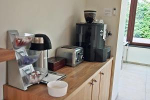 a kitchen counter with a toaster and a blender at Hôtel - Ferme du Château d'Ahin in Huy