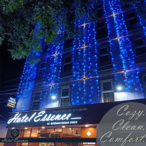 a building with blue lights on the side of it at Hotel ESSENCE in Vellore