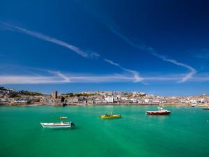 a group of boats in a large body of water at Sandyfeet in Camborne