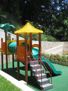 a playground with a slide and a play structure at Ilha Porchat Hotel in São Vicente