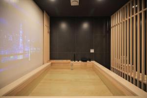 an empty room with black walls and a wooden floor at Aank Ryokan Hotel Paju in Paju