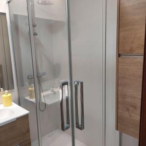 a shower with a glass door in a bathroom at Awesome central house with 3 bedrooms in Ceuta