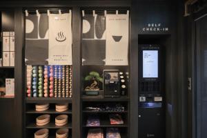 a self checkout in a store with a cash machine at Aank Ryokan Hotel Paju in Paju