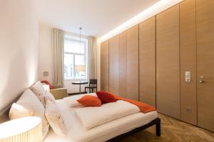 A bed or beds in a room at Hollmann Beletage Design & Boutique Hotel