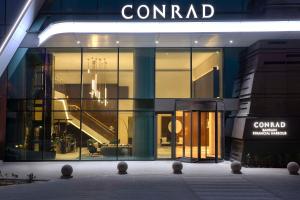 a building with a sign on the side of it at Conrad Bahrain Financial Harbour in Manama