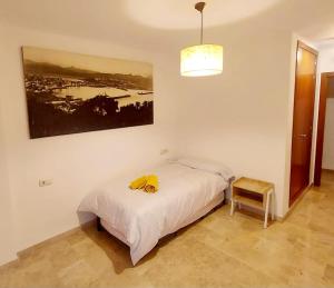 a bedroom with a bed and a picture on the wall at Awesome central house with 3 bedrooms in Ceuta