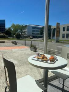 a plate of food on a table on a patio at Premiere Classe Toulouse Sud Labege in Labège