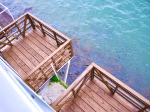 - une vue sur une terrasse en bois à côté de l'eau dans l'établissement ホワイトハウス, à Sasebo