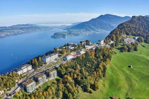 an aerial view of a resort on a hill next to a lake at Bürgenstock Hotels & Resort - Taverne 1879 in Bürgenstock