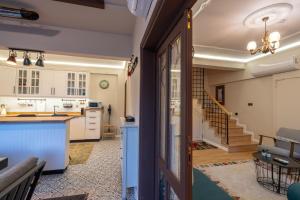 an open kitchen and living room with a staircase at Cozy Home in Oldtown Kaleici in Antalya