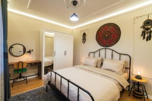 a bedroom with a large bed and a mirror at Cozy Home in Oldtown Kaleici in Antalya