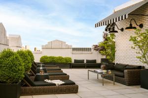 un patio en la azotea con sofás y mesas en un edificio en Sonder at One Platt en Nueva York