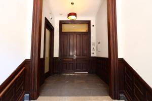 a hallway with a wooden door in a building at Furnished Newbury Street Studio, #6 in Boston