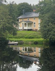 una casa con un reflejo en un cuerpo de agua en Disponenten en Ulvshyttan