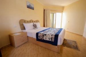 a bedroom with a large bed and a window at Andalusia Blue Beach Hurghada in Hurghada