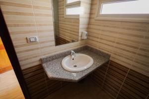 a bathroom with a sink and a mirror at Andalusia Blue Beach Hurghada in Hurghada