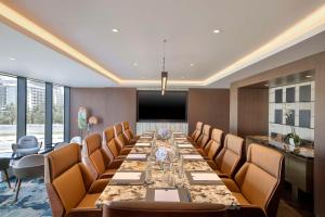 a conference room with a long table and chairs at Conrad Bahrain Financial Harbour in Manama