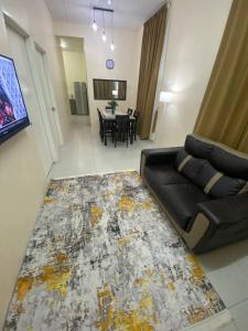 a living room with a couch and a table at Homestay Rumoh Mok in Jitra