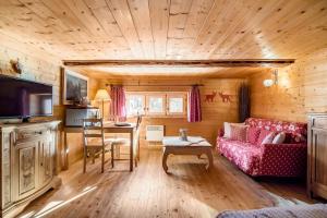 un soggiorno con divano e tavolo di "CHALET dei FIORI" room & apartment a Bedretto