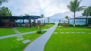 a walkway with tables and chairs in a park at Hotel Sete Ilhas in Florianópolis