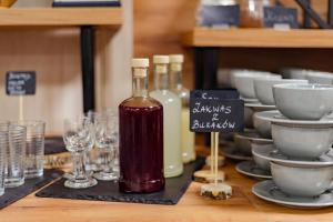 a table topped with glasses and bottles of wine at Hotel 107 in Rumia