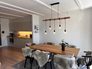 a dining room with a wooden table and chairs at Luxury Holiday Home With Sea View in Gråsten