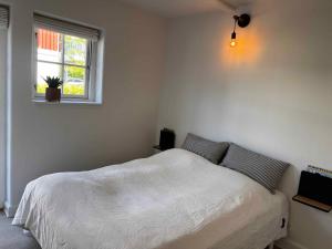 a bedroom with a white bed and a window at Luxury Holiday Home With Sea View in Gråsten