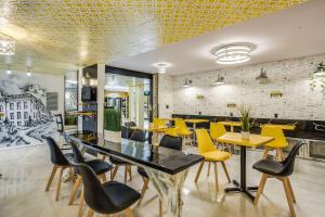 une salle à manger avec des chaises jaunes et une table dans l'établissement Clarion Pointe Tallahassee-State Capitol, à Tallahassee