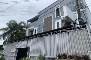 un gran edificio blanco con una valla delante en OYO 94115 Pondok Sahabat Vianty en Pakato