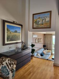 a living room with a couch and a table at Bonita vivienda pareada con piscina privada in Roquetas de Mar